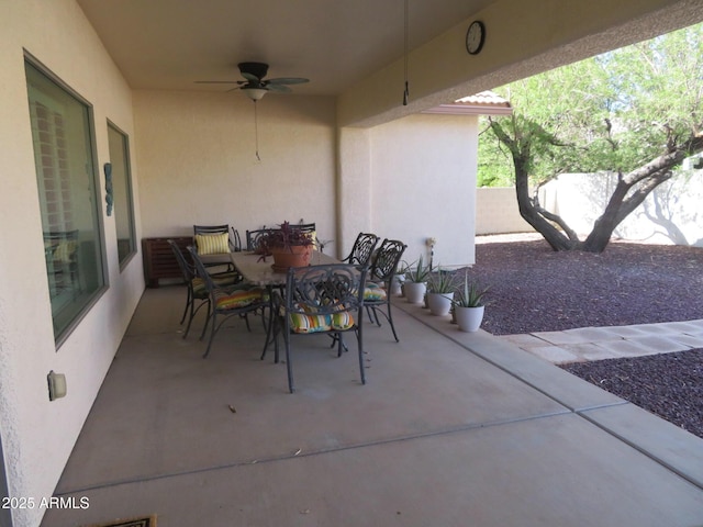view of patio / terrace with outdoor dining area, a ceiling fan, and fence