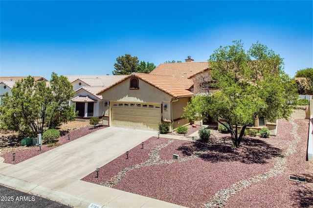 view of front facade with an attached garage, stucco siding, a chimney, concrete driveway, and a tiled roof