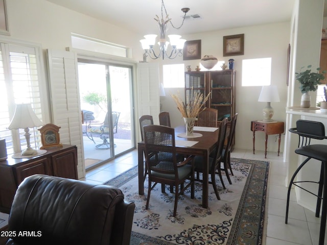 dining space featuring a notable chandelier, light tile patterned floors, and visible vents