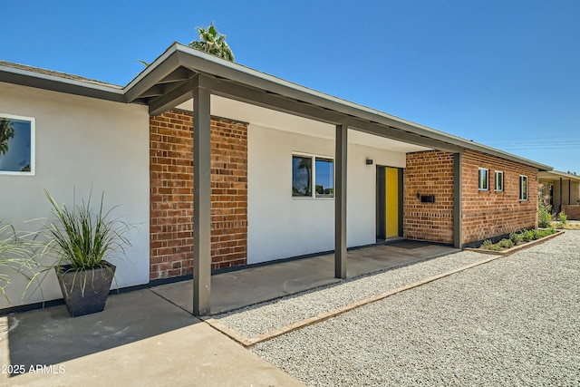 1930 E Missouri Ave, Phoenix, AZ 85016 - doorway to property featuring stucco siding and brick siding