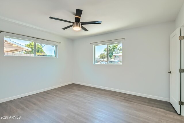 1930 E Missouri Ave, Phoenix, AZ 85016 - unfurnished bedroom with wood finished floors, baseboards, and a ceiling fan