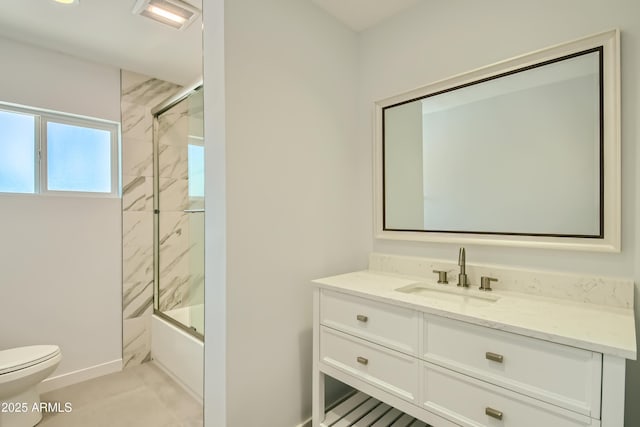 1930 E Missouri Ave, Phoenix, AZ 85016 - full bathroom featuring toilet, vanity, baseboards, and shower / bath combination with glass door