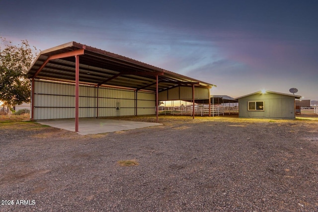 22914 W Sunland Ave, Buckeye, AZ 85326 - outdoor structure at dusk featuring an outdoor structure and an outbuilding