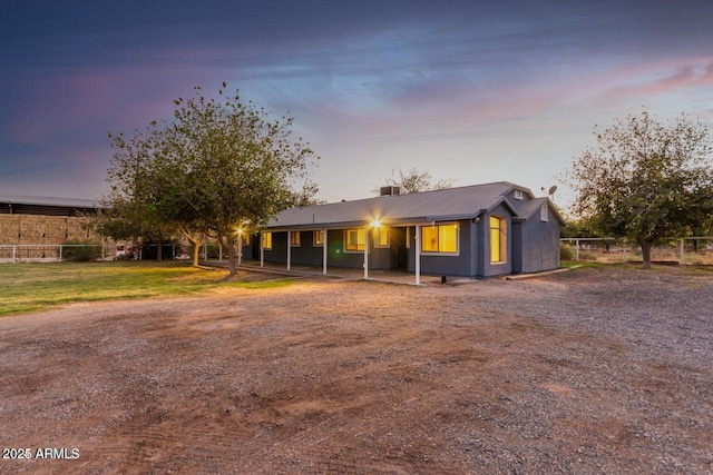 22914 W Sunland Ave, Buckeye, AZ 85326 - view of front of home featuring metal roof, fence, and a chimney
