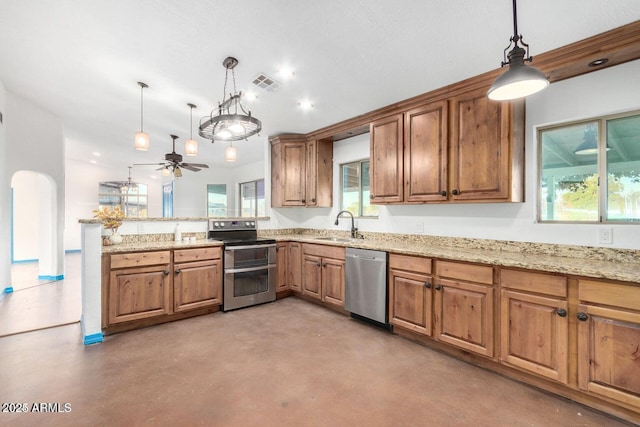 22914 W Sunland Ave, Buckeye, AZ 85326 - kitchen with appliances with stainless steel finishes, a sink, brown cabinets, and concrete floors