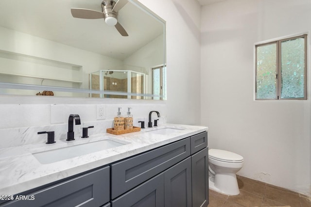 22914 W Sunland Ave, Buckeye, AZ 85326 - bathroom featuring a stall shower, toilet, tile patterned flooring, a ceiling fan, and double vanity