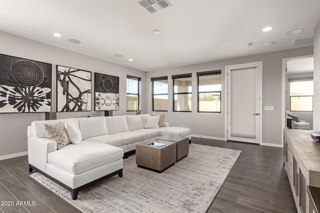 living area featuring recessed lighting, dark wood-style flooring, visible vents, and baseboards