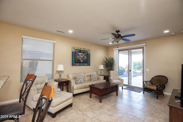 tiled living room with ceiling fan