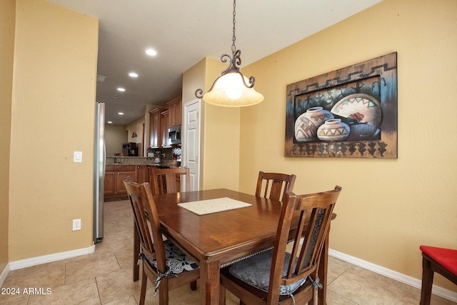 dining space featuring light tile patterned floors