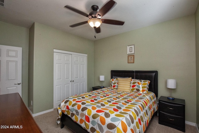 bedroom with light colored carpet, a closet, and ceiling fan