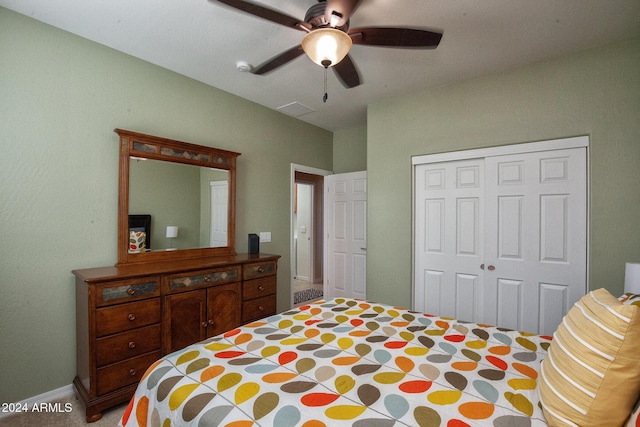 carpeted bedroom with ceiling fan and a closet