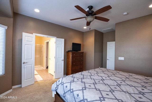 carpeted bedroom with connected bathroom and ceiling fan