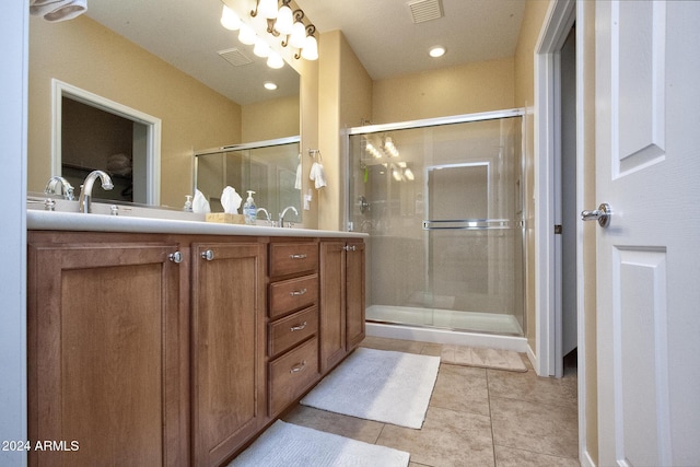 bathroom with vanity, tile patterned floors, and a shower with door