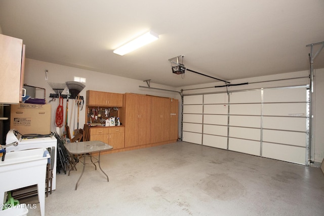 garage with washer / dryer and a garage door opener