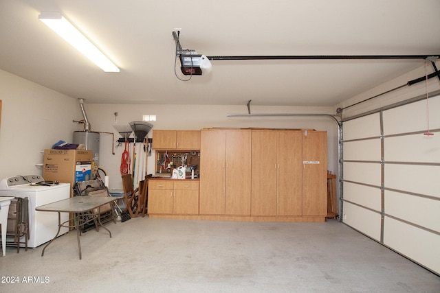 garage with independent washer and dryer, gas water heater, and a garage door opener