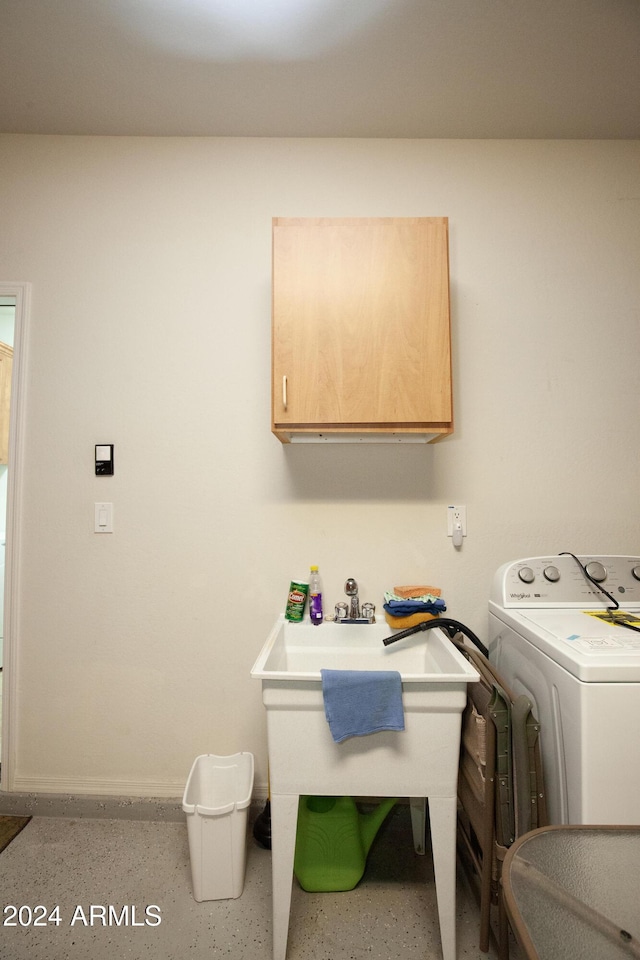 laundry area with washer / clothes dryer and cabinets