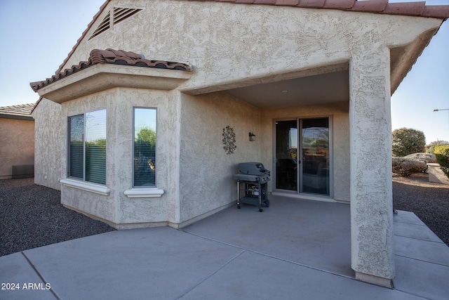 doorway to property with a patio area