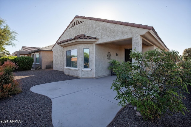 rear view of property featuring a patio area