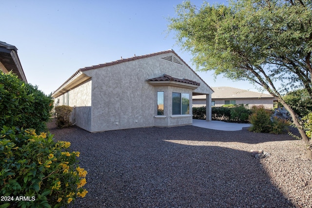 back of house with a patio area