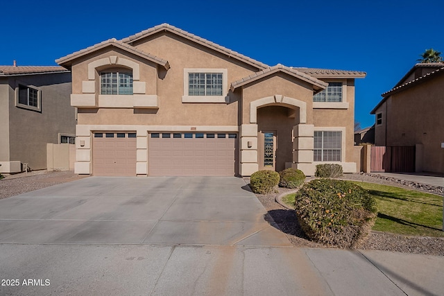 mediterranean / spanish-style home with a garage and central air condition unit