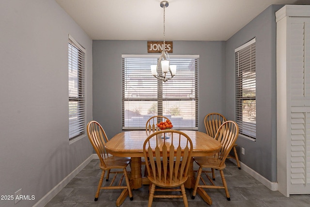 dining space with an inviting chandelier