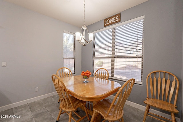 tiled dining space featuring an inviting chandelier