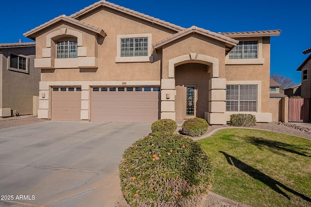 mediterranean / spanish home with a front lawn and a garage