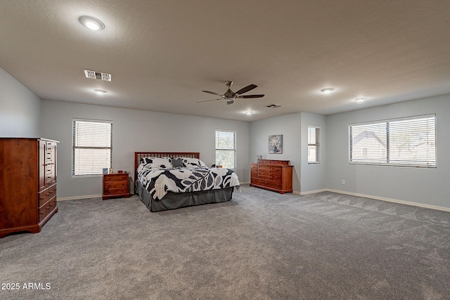 bedroom with carpet flooring, ceiling fan, and multiple windows