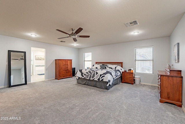 carpeted bedroom featuring a textured ceiling, ceiling fan, and connected bathroom