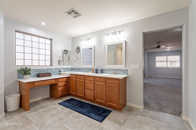 bathroom with tile patterned flooring, ceiling fan, tasteful backsplash, and vanity