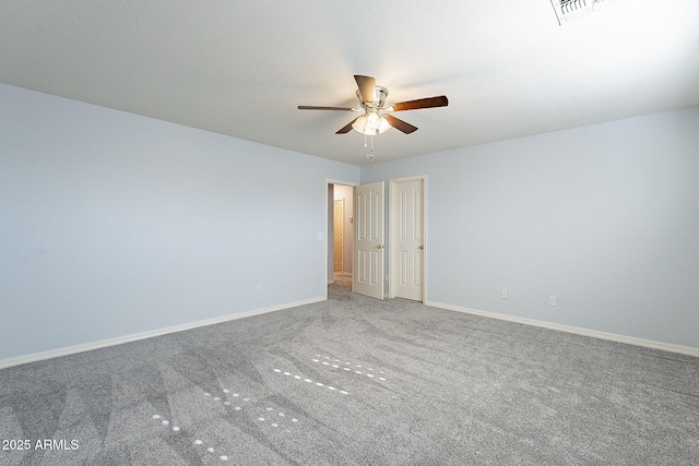 carpeted spare room featuring ceiling fan