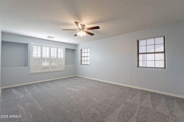 spare room with ceiling fan and carpet