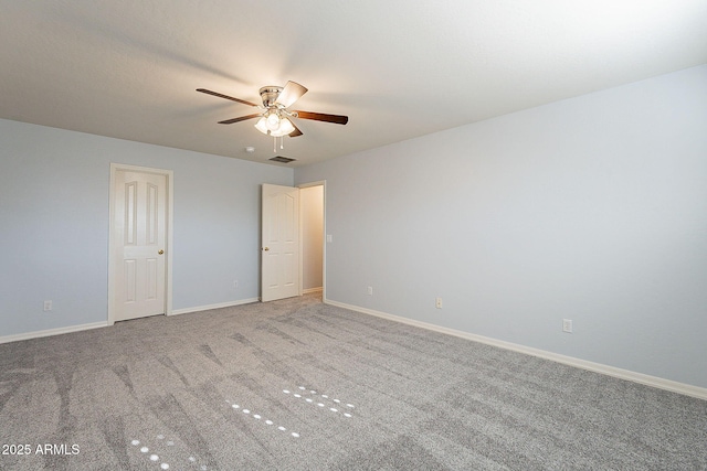 spare room featuring ceiling fan and carpet