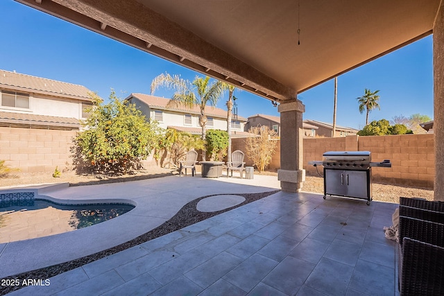 view of patio featuring an outdoor fire pit and a grill