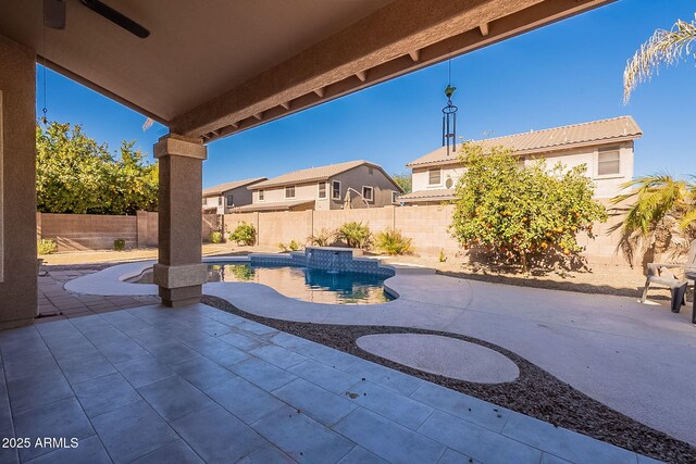 view of patio with ceiling fan and a fenced in pool