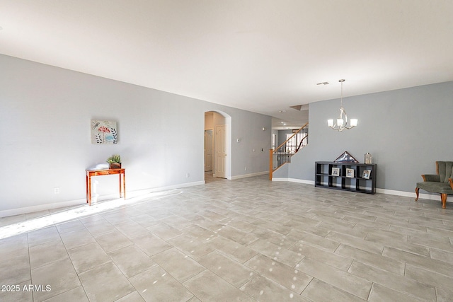 unfurnished living room with a notable chandelier