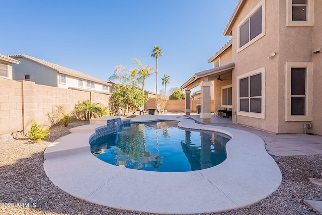 view of swimming pool with pool water feature, a patio area, and ceiling fan