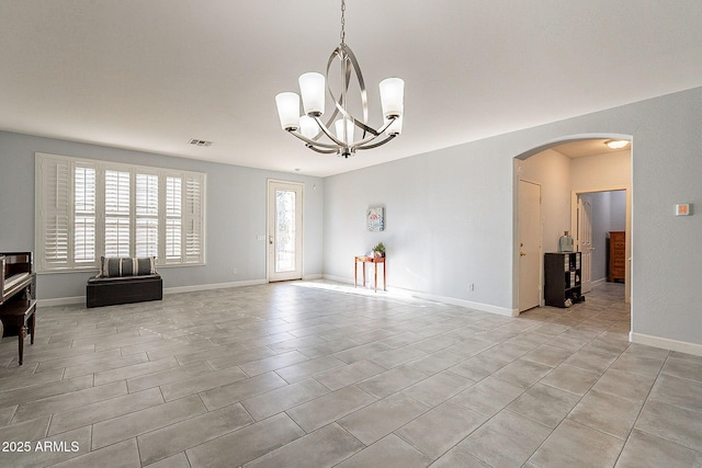 spare room featuring a notable chandelier