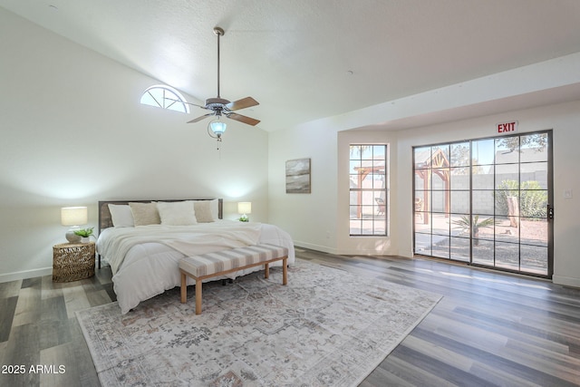 bedroom featuring access to outside, ceiling fan, and dark wood-type flooring