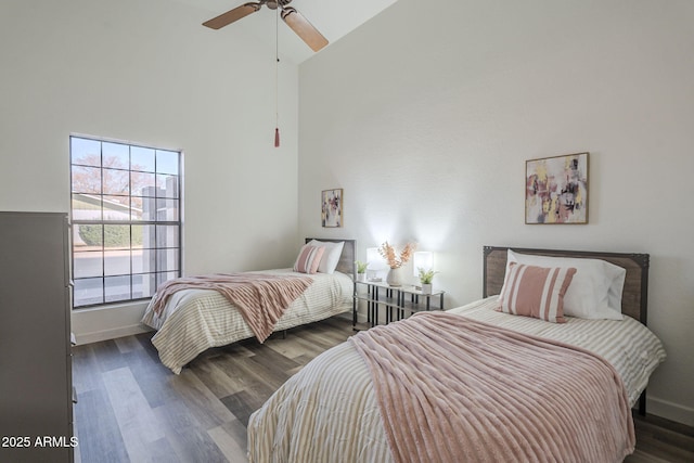 bedroom featuring ceiling fan, dark hardwood / wood-style flooring, and high vaulted ceiling