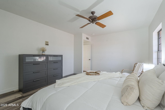 bedroom featuring ceiling fan and dark hardwood / wood-style floors