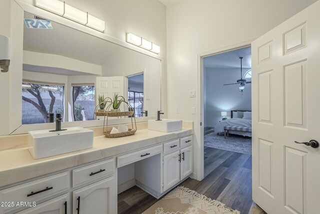 bathroom with vanity, hardwood / wood-style flooring, vaulted ceiling, and ceiling fan