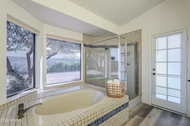 bathroom featuring separate shower and tub, lofted ceiling, and hardwood / wood-style flooring