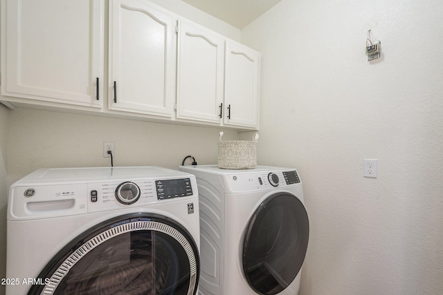 laundry area with cabinets and washing machine and clothes dryer