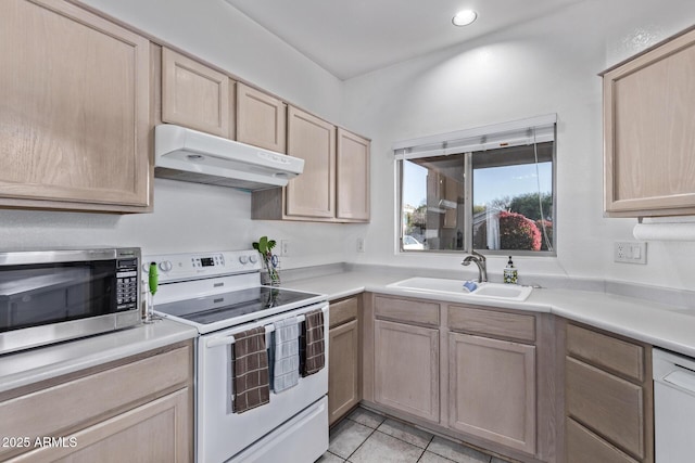 kitchen featuring sink, white appliances, light tile patterned floors, and light brown cabinets