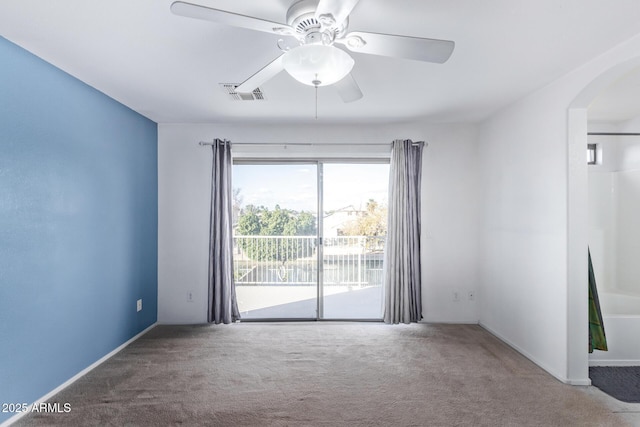 carpeted spare room featuring ceiling fan