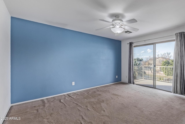 carpeted empty room featuring ceiling fan