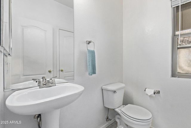 bathroom featuring toilet and sink