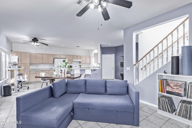 living room featuring ceiling fan and light tile patterned flooring