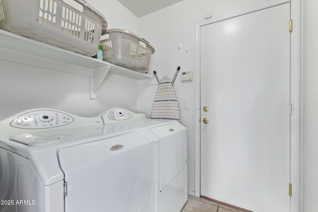 laundry room with independent washer and dryer and light tile patterned flooring